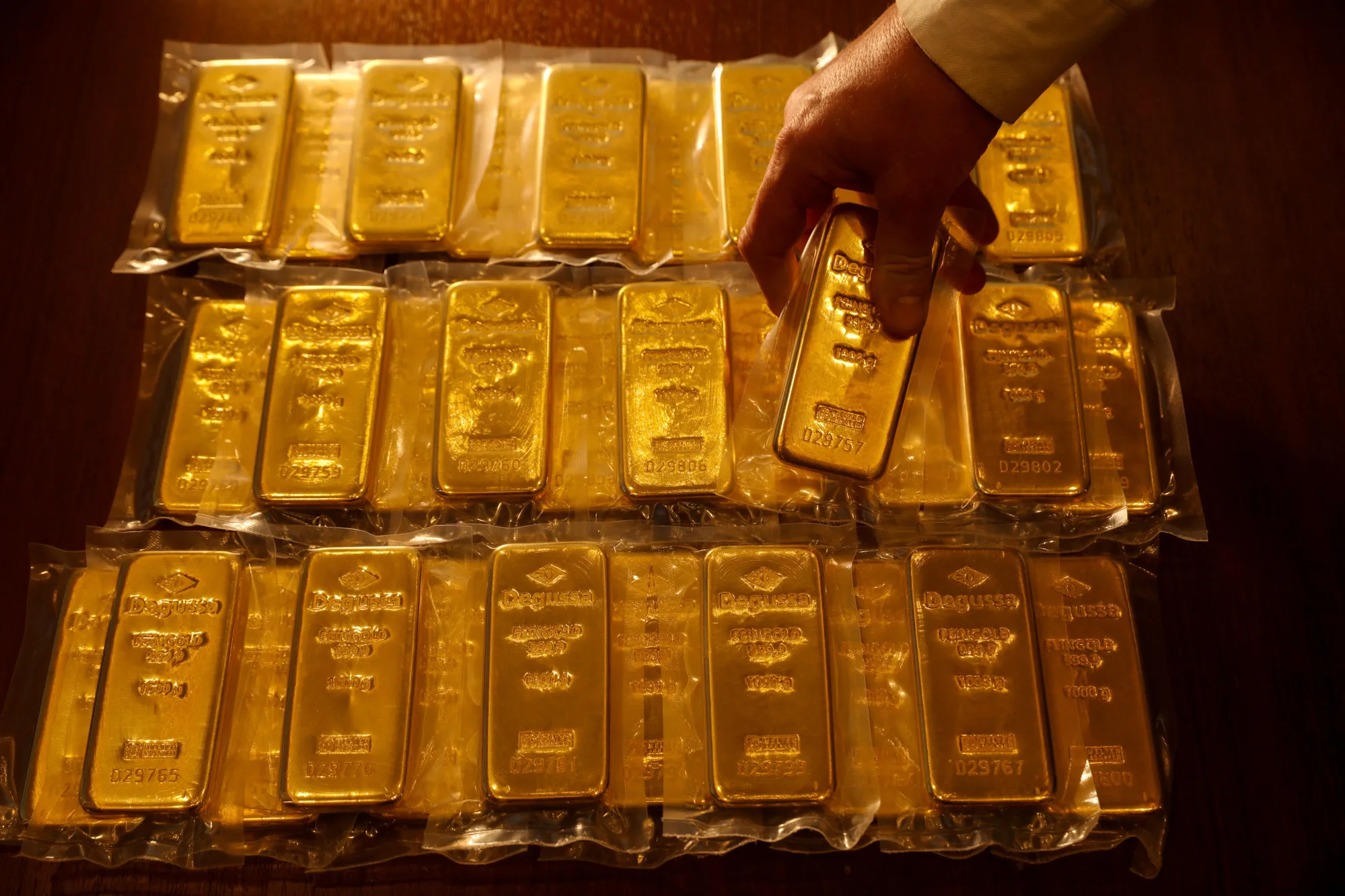 Digital vault with gold bars connected by blockchain technology representing tokenized gold assets