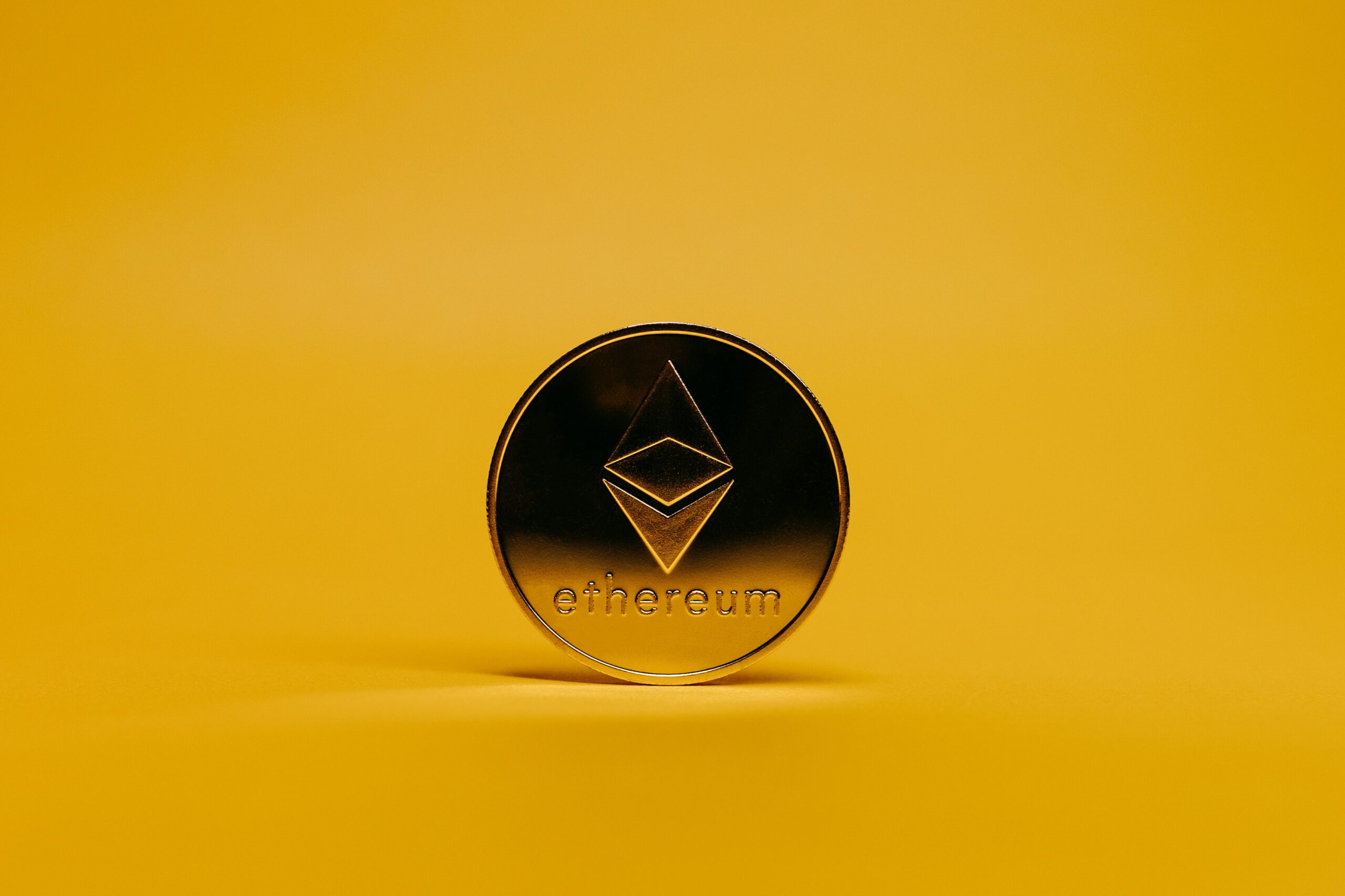 Investors using a tablet to review digital wallets and gold token prices for tokenized gold investments